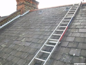 project for slate roofing in nantwich - image shows our roofer setting up his ladder on roof